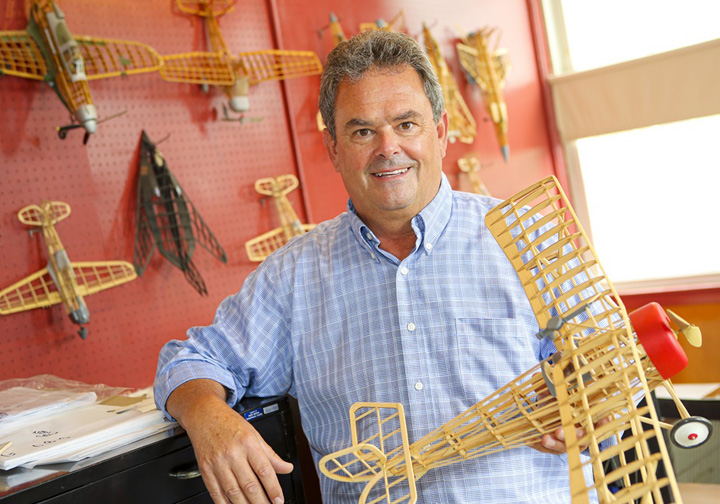 Thomas Barker holding a built balsa wood model kit